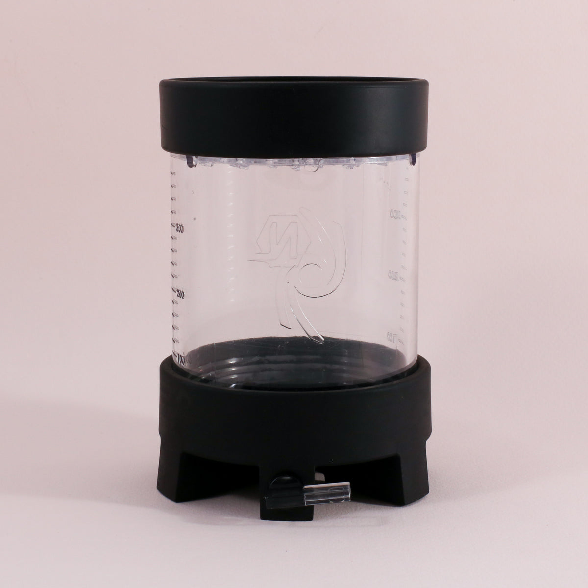 The Tandem Coffee Roasters NextLevel Pulsar Brewer is a clear cylindrical manual coffee maker with a black lid and base, spout at the bottom, adjustable flow valve, side measurement markings, and an etched logo on the front.