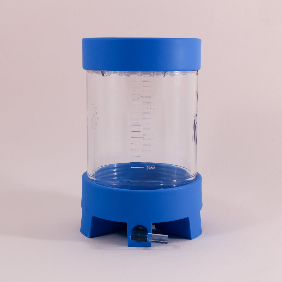The NextLevel Pulsar Brewer by Tandem Coffee Roasters is a clear plastic container with a blue base and lid, measurement markings, and a bottom spout with adjustable flow valve for precise dispensing, shown on a plain light background.